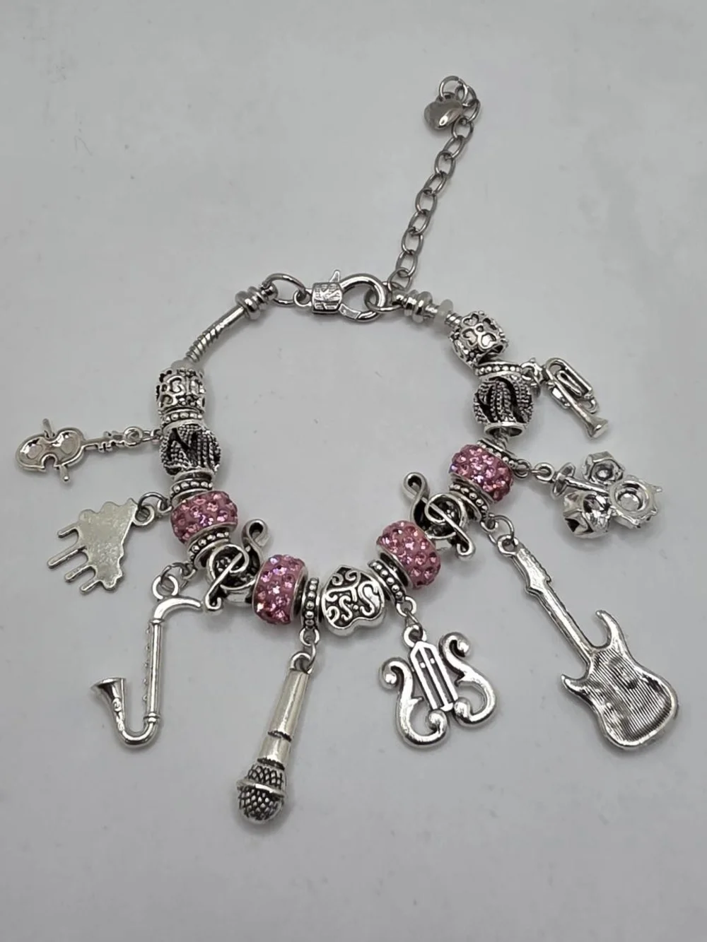 Silver Music Charm Bracelet with Pink Accents